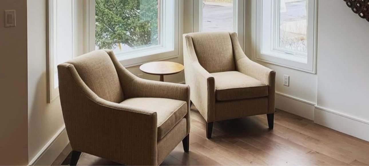 Comfortable modern seating area with large windows